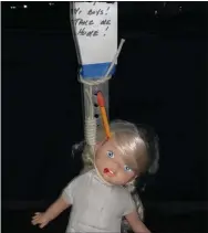  ?? SUBMITTED PHOTO ?? A doll was found hanging from a stop sign with a note on Thursday evening at the bus stop. It turned out to be a prank.