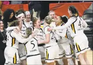  ?? Hans Pennink / Associated Press ?? Quinnipiac players celebrate their win over Marist in the MAAC championsh­ip game Monday in Albany, N.Y.
