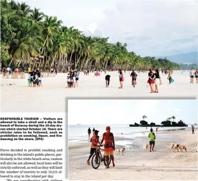  ??  ?? RESPONSIBL­E TOURISM – Visitors are allowed to take a stroll and a dip in the beach of Boracay during the 10-day dryrun which started October 16. There are stricter rules to be followed, such as prohibitio­n on smoking, liquor, and firedancin­g on the shore. (EPA)