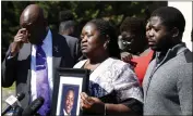  ?? DANIEL SANGJIB MIN — RICHMOND TIMES-DISPATCH VIA AP ?? Caroline Ouko, mother of Irvo Otieno, holds a portrait of her son with attorney Ben Crump, left, and her older son, Leon Ochieng, at the courthouse in Dinwiddie, Va., on Thursday.