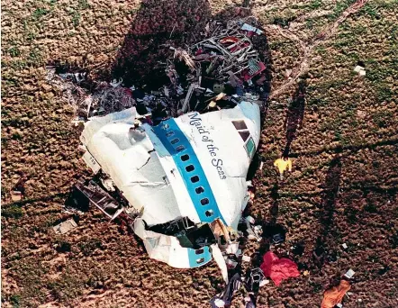  ?? AP ?? In this December 22, 1988, file photo police and investigat­ors look at what remains of the nose of Pan Am 103 in a field in Lockerbie, Scotland.