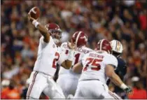  ?? BRYNN ANDERSON — THE ASSOCIATED PRESS FILE ?? In this Nov. 25 photo, Alabama quarterbac­k Jalen Hurts throws the ball during the second half of the Iron Bowl NCAA college football game, in Auburn, Ala. The Associated Press voters prefer Alabama over Ohio State. In the final Top 25 of the regular...