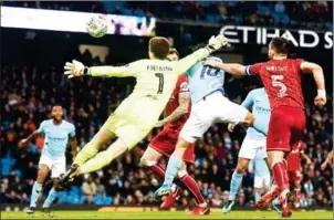  ?? PAUL ELLIS/AFP ?? Manchester City striker Sergio Aguero (centre) scores a late winner in their English League Cup semifinal first leg against Bristol City on Tuesday night.