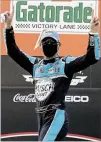  ??  ?? Victory Lane looks a little different as a masked Kevin Harvick celebrates his Cup Series win Sunday at Darlington.