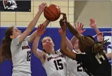  ?? CHRIS CHRISTO — BOSTON HERALD ?? From left, Brookline’s Talia Thompson, Faith Rothstein and Gigi McMahon go for a rebound against Springfiel­d Central’s Julie Bahati. Brookline was ousted in state tournament play, 65-52.