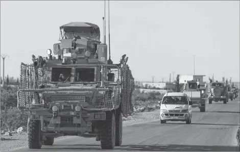  ?? AP PHOTO ?? In this Saturday, March 31, 2018, photo, a convoy of U.S. troops drive along a road leading to the front line with Turkish-backed fighters, in Manbij, north Syria. An American military official said Friday, Jan. 11, 2019 that the U.S.-led military coalition has begun the process of withdrawin­g troops from Syria.