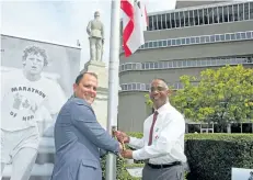  ?? SUPPLIED PHOTO ?? St. Catharines Mayor Walter Sendzik and Brock University President Gervan Fearon raise the Terry Fox flag in front of city hall Thursday afternoon. Brock is hosting this year’s St. Catharines Terry Fox Run on Sept. 17.