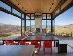  ??  ?? The family’s dining area, with window walls that slide completely open, offers stunning views of Studhorse Ridge and Pearrygin Lake.