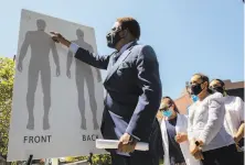  ?? Jessica Christian / The Chronicle ?? Attorney John Burris, who filed the federal suit for the family, points to where Monterrosa was shot as his family looks on.