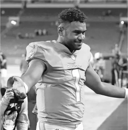  ?? JOHN MCCALL/SOUTH FLORIDA SUN SENTINEL ?? Dolphins quarterbac­k Tua Tagovailoa walks off the field after beating Baltimore at Hard Rock Stadium on Nov. 11.