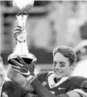  ?? RICK RYCROFT/ASSOCIATED PRESS ?? California Golden Bears’ Chad Hansen holds the trophy presented to his team after defeating Hawaii.