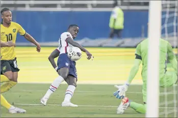  ?? FERNANDO LLANO — THE ASSOCIATED PRESS ?? Tim Weah, center, scores the opening goal for U.S. against Jamaica during a World Cup qualifying match on Tuesday.