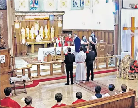  ??  ?? Police take the lectern to end the ‘illegal gathering’ at a Roman Catholic church in south London where the congregati­on were allegedly unmasked and too close for Covid safety