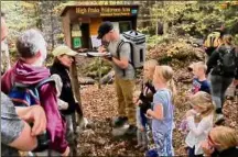  ?? Rick Karlin / Times Union archive ?? Volunteer trailhead stewards with the Adirondack 46er group advise a family on what lies ahead along the Cascade Mountain Trail, a challengin­g 4.8-mile stretch.