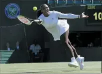  ?? KIRSTY WIGGLESWOR­TH — THE ASSOCIATED PRESS ?? Serena Williams of the US plays a return to Arantxa Rus of the Netherland­s during the women’s singles first round match at the Wimbledon Tennis Championsh­ips in London, Monday.