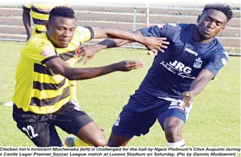  ??  ?? Chicken Inn’s Innocent Mucheneka (left) is challenged for the ball by Ngezi Platinum’s Clive Augusto during a Castle Lager Premier Soccer League match at Luveve Stadium on Saturday. (Pic by Dennis Mudzamiri)