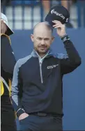  ?? AP photo ?? Brian Harman acknowledg­es the crowd on the 18th green after an eagle putt concluded his 6-under 65 in the second round of the British Open on Friday.