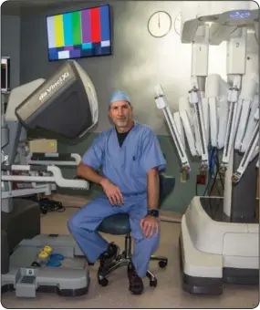  ?? Photo by Janda White ?? USA pediatric surgeon Dr. Curt Koontz pictured with the robotic surgery console and arms in the operating room.