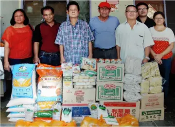  ??  ?? Lim (third left) and James (fourth left) during presentati­on of donations.