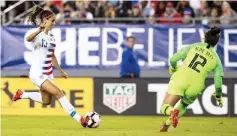  ??  ?? United States forward Alex Morgan (left) shoots on goal against Brazil goalkeeper Aline during the first half during a She Believes Cup women’s match at Raymond James Stadium in this March 5 file photo. — USA TODAY Sports photo