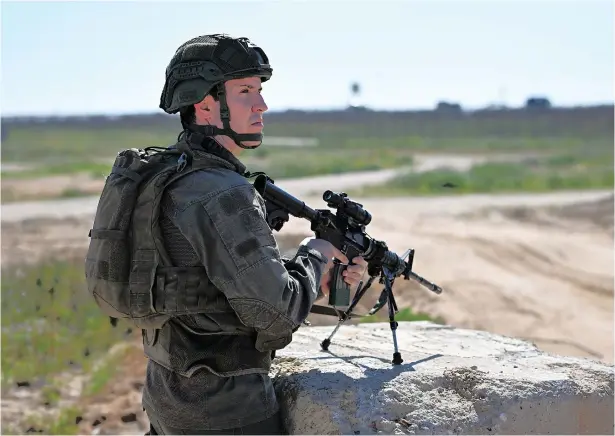  ?? (Dylan Martinez/Reuters) ?? A SOLDIER stands guard near the Kerem Shalom crossing this week.