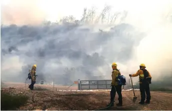  ?? — AFP photo ?? Firefighte­rs work during the Silverado Fire in Orange County in Irvine, California.