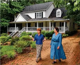  ?? CHARLOTTE B. TEAGLE/AJC STAFF 2014 ?? ReMax Realtors Martha Scarbrough (left) and Marilyn Meacham visit a house in Norcross on the market. New homes in Atlanta have been getting bigger, creating a wider gap in median sales prices between new and resale homes.