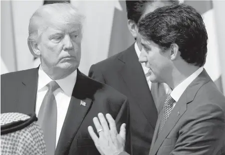  ??  ?? U.S. President Donald Trump talks with Prime Minister Justin Trudeau at the G20 Summit in Hamburg, Germany, on Saturday. Trump said of Trudeau: “We have a great neighbour in Canada, and Justin is doing a spectacula­r job in Canada.”