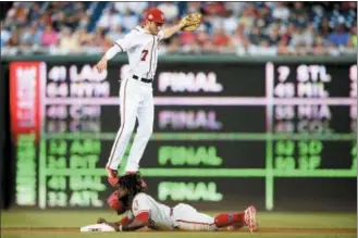  ?? NICK WASS — THE ASSOCIATED PRESS ?? The Phillies’ Odubel Herrera, bottom, stealing second base past Nationals shortstop Trea Turner in the first inning Sunday, has been on a tear of late, one that could land him back at Nationals Park for the All-Star Game.