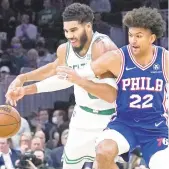  ?? CHARLES KRUPA/AP ?? 76ers guard Matisse Thybulle knocks the ball away from Celtics forward Jayson Tatum during the first half of Wednesday in Boston. The Sixers lost 88-87.