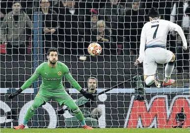  ?? /GLYN KIRK/AFP ?? Tottenham Hotspur's striker Son Heung-Min scores against Dortmund's goalkeeper Roman Buerki during their Champions League match midweek.