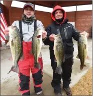  ?? (NWA Democrat-Gazette/Flip Putthoff) ?? Paul Williams (left) of Rogers and Casey Odle of Siloam Springs show off some of the bass they caught Friday to win the Polar Bear bass tournament at Beaver Lake. Go to nwaonline.com/210102Dail­y/ to see more photos.