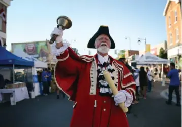  ?? COLE BURSTON/TORONTO STAR ?? Markham’s town crier, John Webster, delivers a rousing call during the Markham Village Music Festival on Friday.