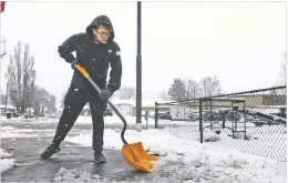  ?? RACHEL GIBBONS ARIZONA DAILY SUN ?? Jovany Martinez shovels the sidewalk around his home as snow falls Tuesday in Flagstaff, Ariz. Some residents of north-central Arizona were told to prepare to evacuate because of rising water levels in rivers and basins.