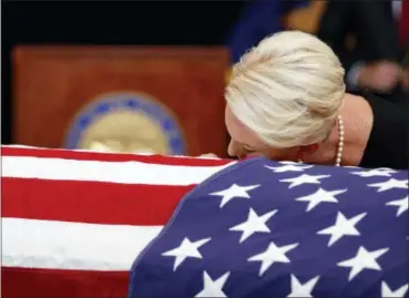 ?? JAE C. HONG — THE ASSOCIATED PRESS ?? Cindy McCain, wife of, Sen. John McCain, R-Ariz. lays her head on the casket during a memorial service at the Arizona Capitol on Wednesday in Phoenix.