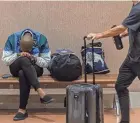  ?? THOMAS CORDY/THE PALM BEACH POST ?? Travelers make their way through the concourses at Palm Beach Internatio­nal Airport Nov. 21, in unincorpor­ated Palm Beach County.