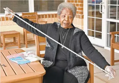  ?? AMY DAVIS/BALTIMORE SUN ?? Bernadette Croaker, 76, who lives in Owings Mills, carries a tape measure to remind fellow residents to keep a safe six feet apart.