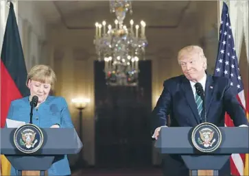  ?? Pablo Martinez Monsivais Associated Press ?? GERMAN CHANCELLOR Angela Merkel appears uncomforta­ble as President Trump mentions a sore point, saying, “As far as wiretappin­g ... by this past administra­tion, at least we have something in common, perhaps.”