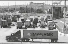  ?? RINGO H.W. CHIU/AP ?? CARGO CONTAINER TRUCKS WAIT IN LINE to enter AMP Terminals at the Port of Los Angeles, Wednesday, in San Pedro, Calif.