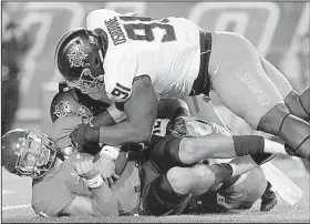  ?? Oklahoma State defensive tackle DeQuinton Osborne AP/DAN ANDERSON ?? (91) sacks South Alabama quarterbac­k Dallas Davis on Friday during the second half of the No. 11 Cowboys’ 44-7 victory over the Jaguars in Mobile, Ala. The Cowboys outgained the Jaguars 505-175 in total yards and held South Alabama to 1-of-10 on third...