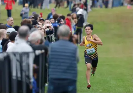  ?? PHOTO BY PAUL CONNORS — MEDIA NEWS GROUP/BOSTON HERALD ?? Greater Lowell’s Devin Moreau approaches the finish line to win the Frank Kelley Invitation­al’s boys championsh­ip race in Wrentham.