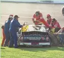  ?? AP ?? Workers work to remove Dale Earnhardt from his vehicle after a crash at the Daytona 500 on Feb. 18, 2001. Earnhardt’s injuries were fatal.