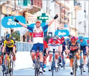  ?? TOMMASO PELAGALLI/AFP ?? Team Trek rider Jasper Stuyven (center) celebrates as he crosses the finish line to win the one-day classic cycling race Milan-San Remo on Saturday.