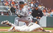  ?? Jason O. Watson, Getty Images ?? Gorkys Hernandez of the San Francisco Giants is forced out at first base by Ian Desmond of the Rockies during the second inning Sunday.