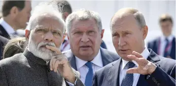  ?? (Alexander Nemenov/Reuters) ?? INDIAN PRIME MINISTER Narendra Modi (left) and Russian President Vladimir Putin (right) visit the Zvezda shipyard, accompanie­d by Rosneft CEO Igor Sechin, ahead of the Eastern Economic Forum in Vladivosto­k, Russia, earlier this month.