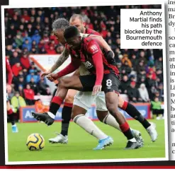  ??  ?? Anthony Martial finds his path blocked by the Bournemout­h defence