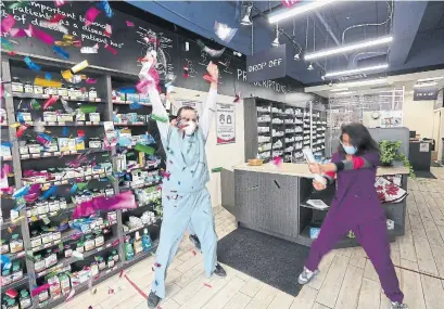  ?? RENÉ JOHNSTON TORONTO STAR ?? Pharmacist Kyro Maseh and his co-workers celebrate administer­ing their 1,000th dose of the AstraZenec­a vaccine on Wednesday. During his vaccinatio­n drive, Maseh and staff celebrate empty vials by ringing a bell and yelling: “Shots in the arm! COVID’s gone!”