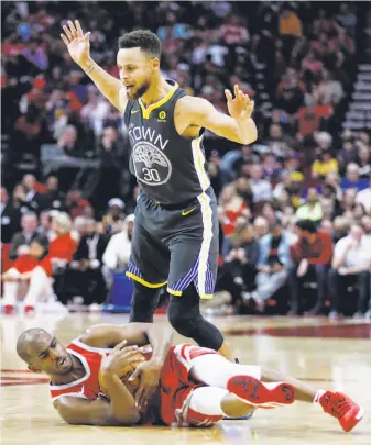  ?? Brett Coomer / Houston Chronicle ?? Rockets guard Chris Paul is knocked to the floor after he was fouled by Warriors guard Stephen Curry during the second quarter in Houston. Paul outscored his counterpar­t 33-19.