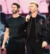  ??  ?? Howard Donald, from left, Gary Barlow and Mark Owen from the band Take That perform on stage.