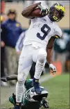  ?? SHAMUS / GETTY IMAGES GREGORY ?? Donovan Peoples-Jones scores the go-ahead TD in the second half for the Wolverines.